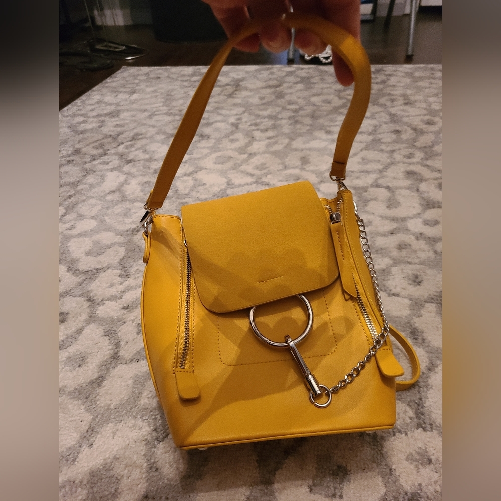 Used but great condition. Yellow top handle or backpack. Chain detail. Lulus